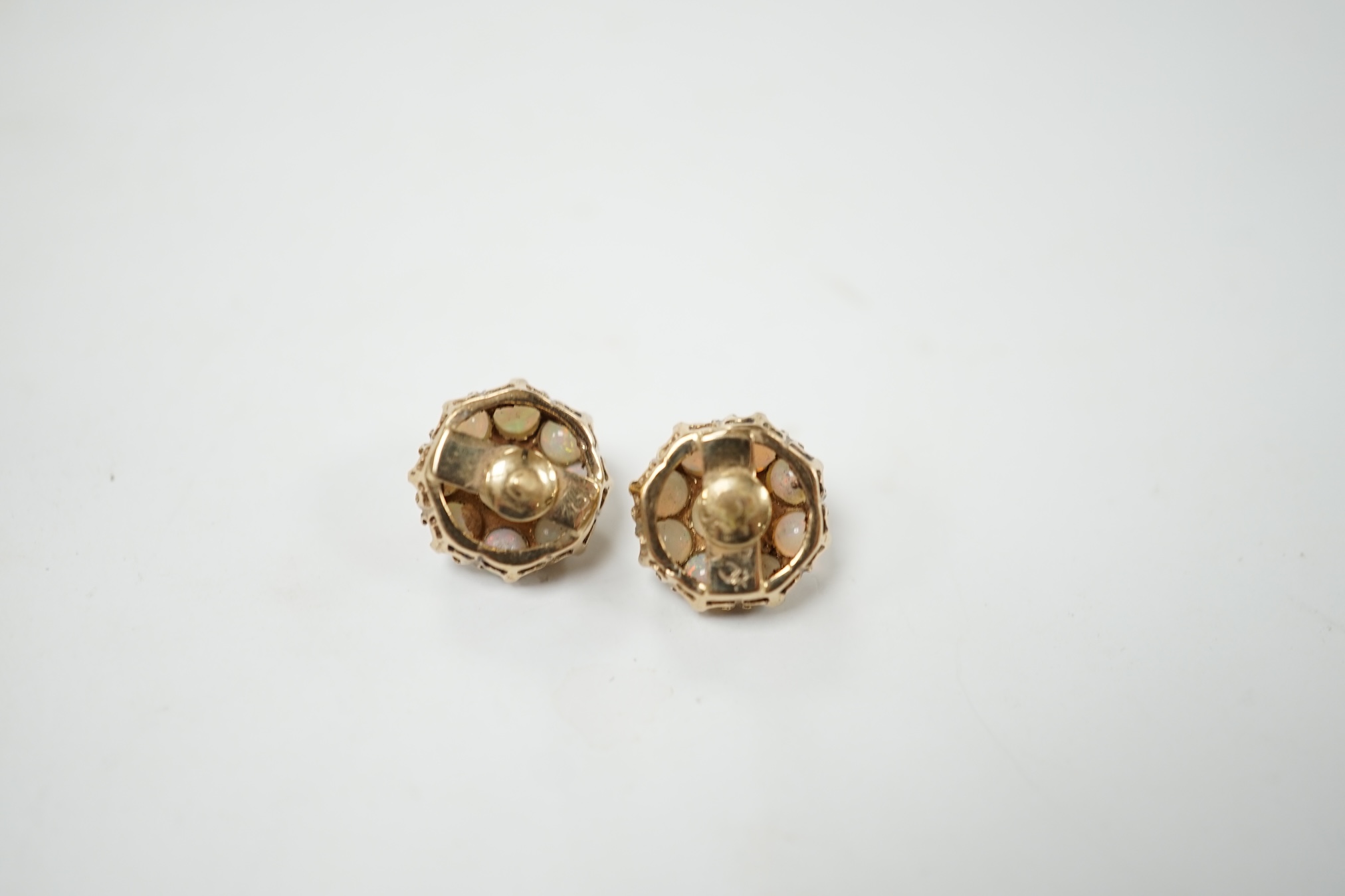 A pair of yellow metal and white opal set flower head cluster earrings, 10mm, 3.3 grams. Condition - fair